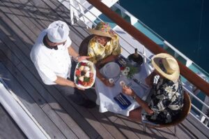 Couple receiving meal on deck of passenger liner-cm