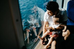 Girl traveling by ship with her father and looking through the window -cm