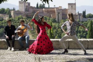 Dancers and musician performing flamenco on sunny day in front of Alhambra, Granada, Spain-cm