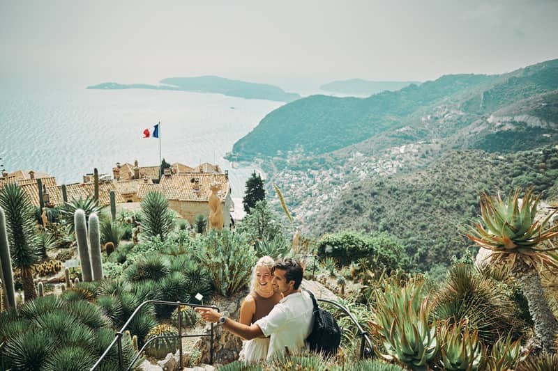 Happy millennial couple, exploring the historic village of Eze in the south of France, while on vacation-cm