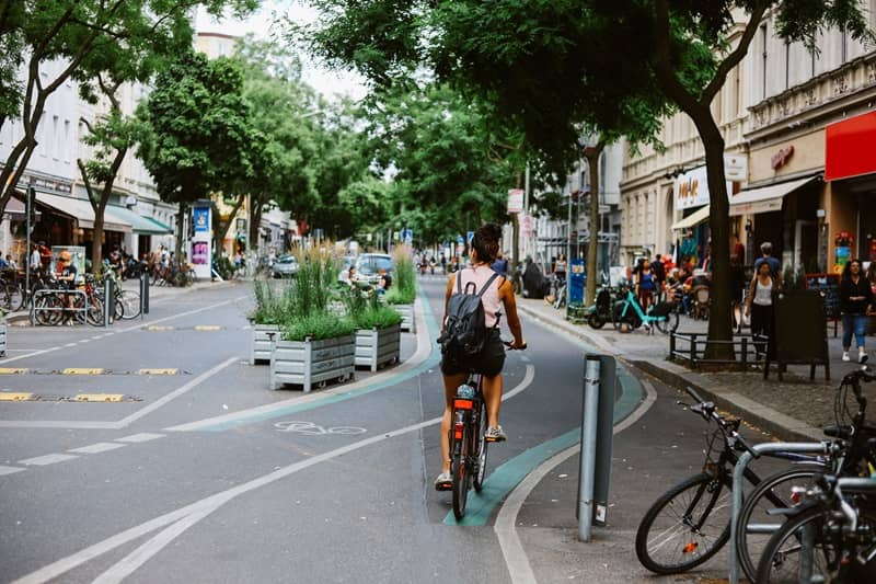 Woman riding a bicycle on the streets of Berlin-cm