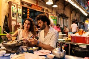Couple enjoying a cozy hot pot dinner side by side-cm