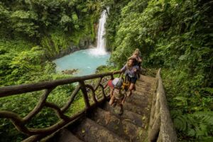 A family hiking at Rio Celeste waterfall in Costa Rica.-cm